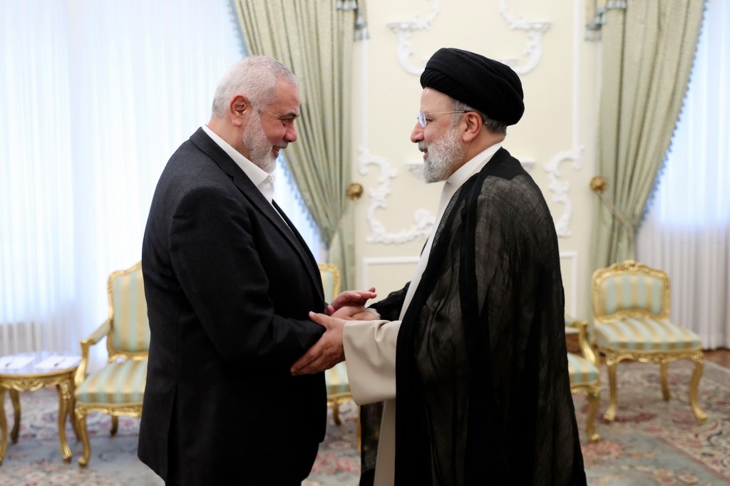 President Ebrahim Raisi, right, shakes hands with Hamas chief Ismail Haniyeh at his office in Tehran, Iran, March 27, 2024.