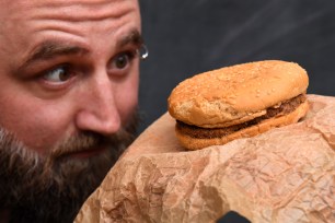 Casey Dean inspects a McDonald's burger he bought in 1995.