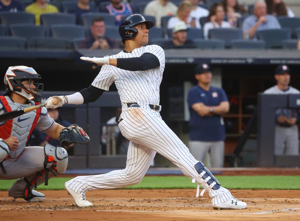 New York Yankees outfielder Juan Soto hitting a 2-run home run during a game against the Houston Astros at Yankee Stadium