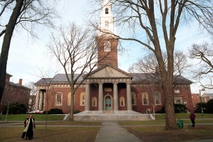 People walking around the brick buildings on Harvard University's main campus in December 2000, when Al Gore was nominated for president of the institution