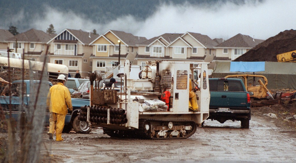 Royal Canadian Mounted Police investigators work with a drilling crew and heavy machinery during an investigation at Robert William Pickton's pig farm.