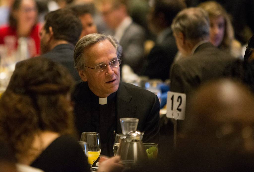 Notre Dame President the Rev. John I. Jenkins, talks to other guests during the 2015 Dr. Martin Luther King Jr. Community Service Breakfast, at the Century Center.