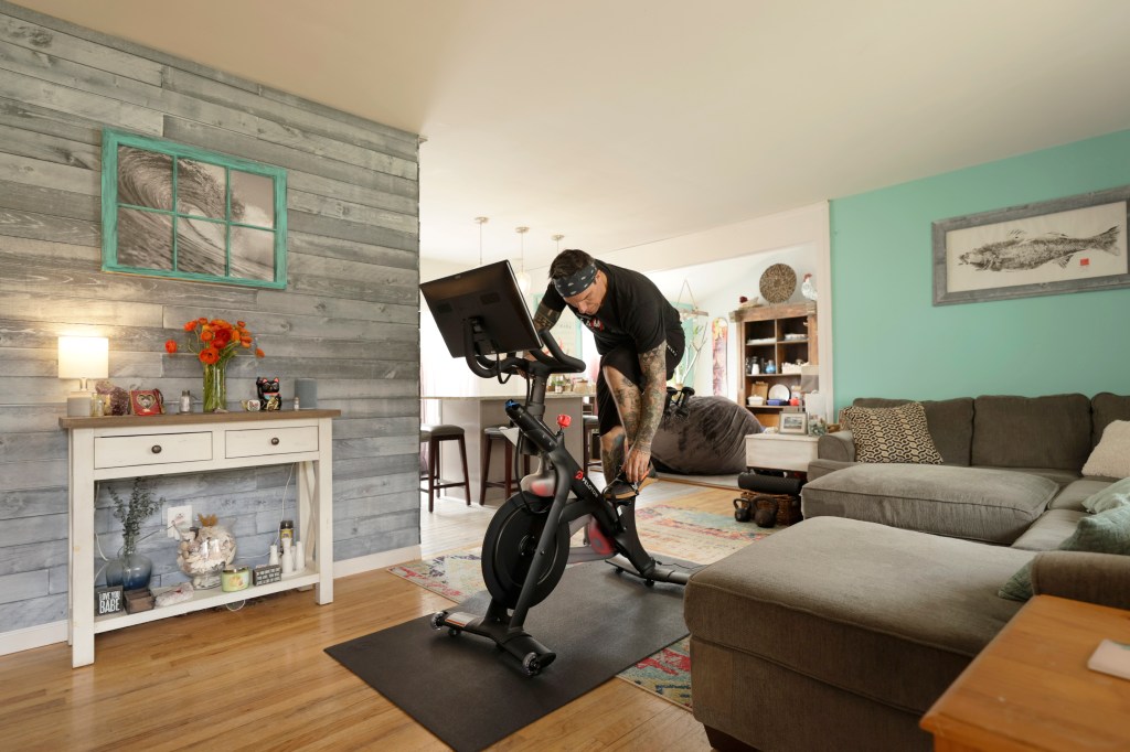 Brody Longo preparing to work out on his Peloton exercise bike at home in Brick, New Jersey during the COVID-19 pandemic