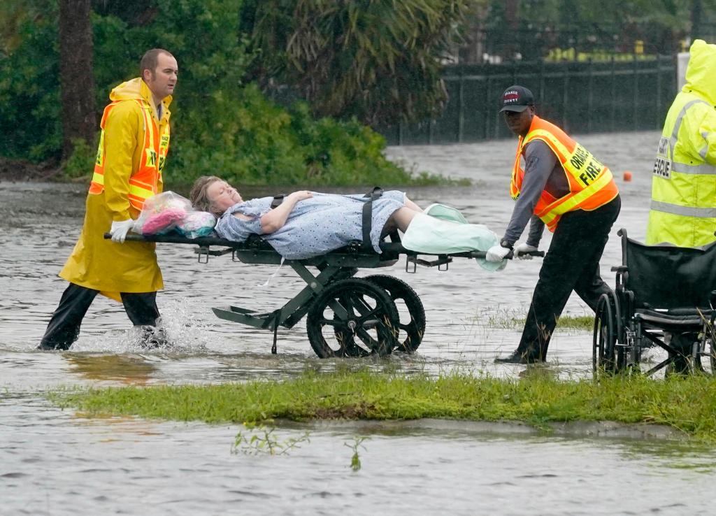 Authorities transport a person out of the Avante nursing home in the aftermath of Hurricane Ian, Thursday, Sept. 29, 2022, in Orlando, Fla. 