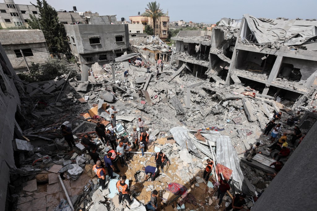 Palestinians inspect the site of an Israeli strike on a house, in Nuseirat, in the central Gaza Strip, May 19, 2024.
