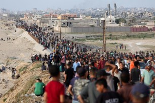 Palestinians gather in the hope of obtaining aid delivered into Gaza through a U.S.-built pier