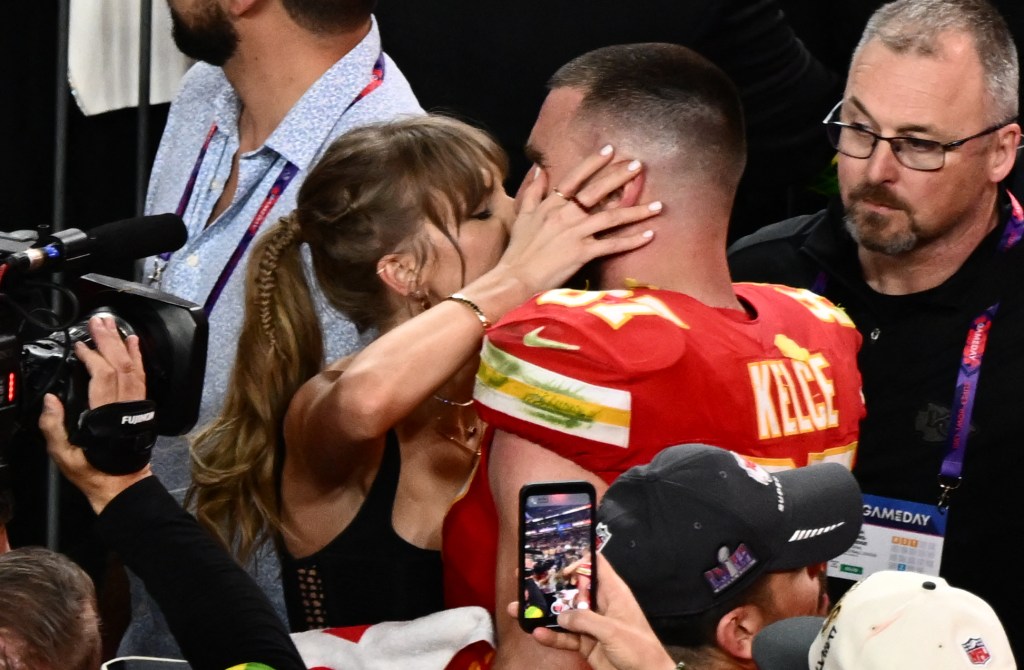 Taylor Swift and Travis Kelce kiss after the Chiefs won Super Bowl LVIII against the San Francisco 49ers at Allegiant Stadium in Las Vegas, Nevada, February 11, 2024.  