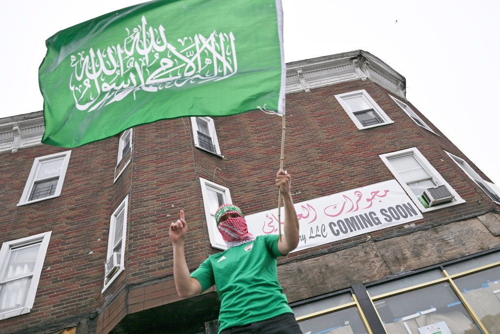 Protester waves Hamas flag. 