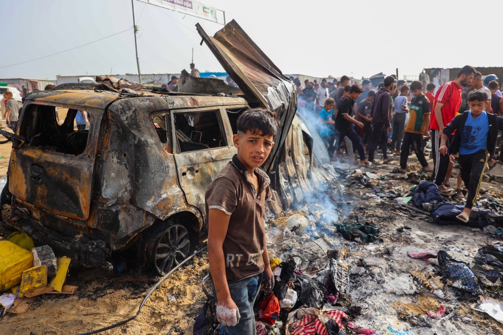 Palestinians saw their camp destroyed by a blaze following an Israeli airstrike in Rafah.