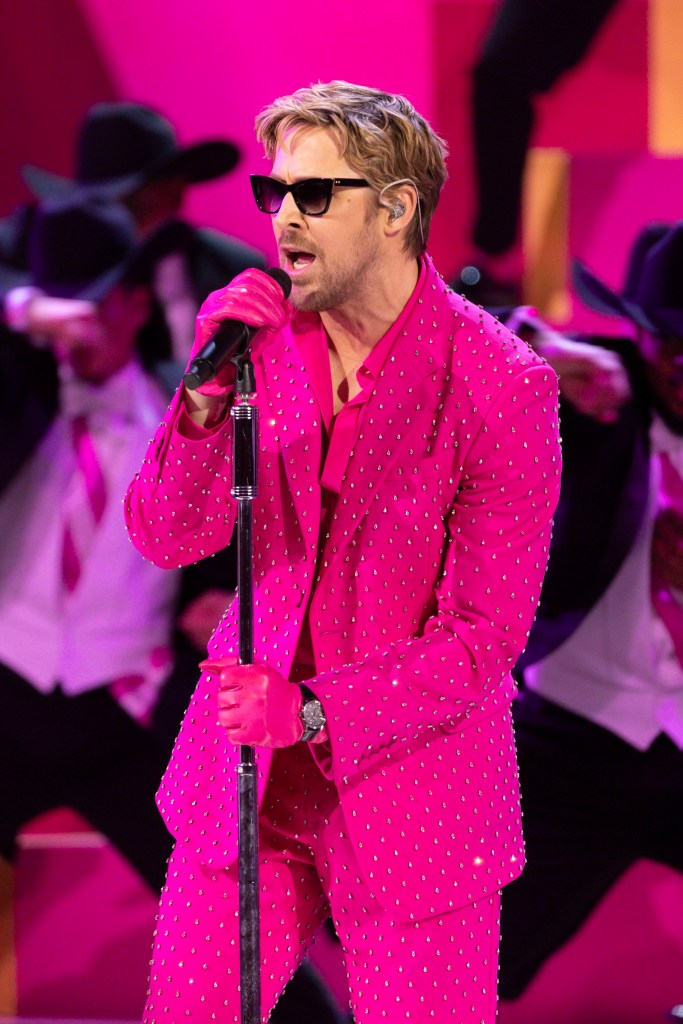 Ryan Gosling in a pink suit singing into a microphone at the 96th Oscars at the Dolby Theatre in Hollywood