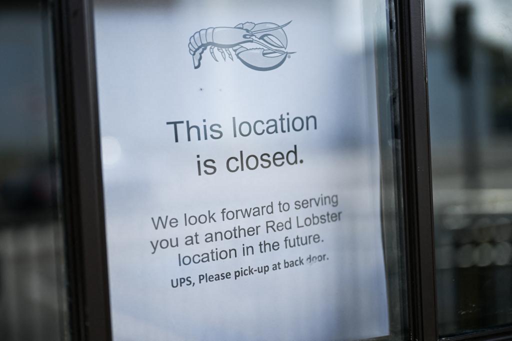 Closed Red Lobster restaurant in Torrance, California with a 'location closed' sign displayed in the window.