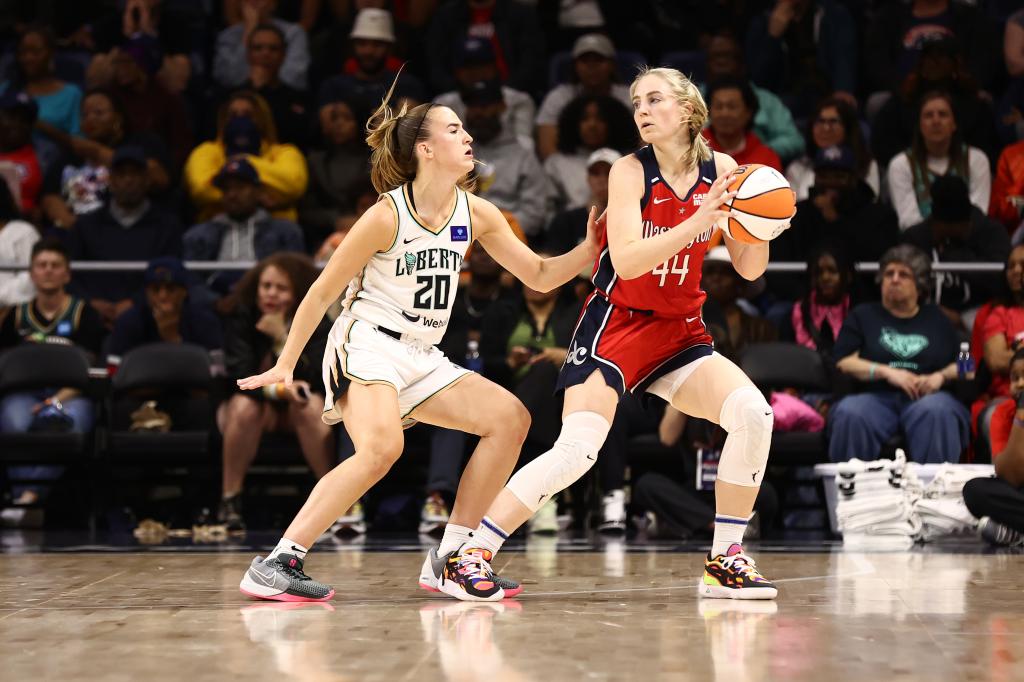 Karlie Samuelson handles the ball during the game as Sabrina Ionescu #20 of the New York Liberty plays defense on May 14, 2024.