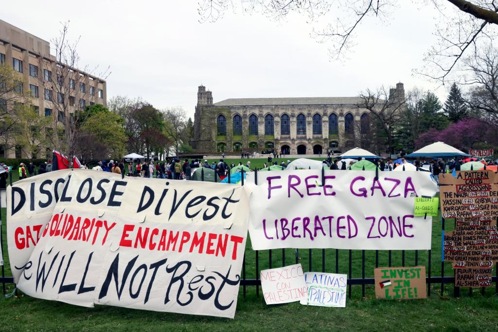 Signs are displayed outside a tent encampment at Northwestern University on Friday, April 26, 2024, in Evanston, Illinois. Leaders from Northwestern University, the University of California, Los Angeles, and Rutgers University are expected to testify before Congress on Thursday, the latest in a series of hearings spearheaded by House Republicans into how colleges have responded to pro-Palestinian protests on their campuses.