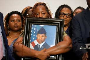 Chantemekki Fortson, mother of Roger Fortson, a U.S. Air Force senior airman, holds a photo of her son during a news conference with attorney Ben Crump, Thursday, May 9, 2024, 