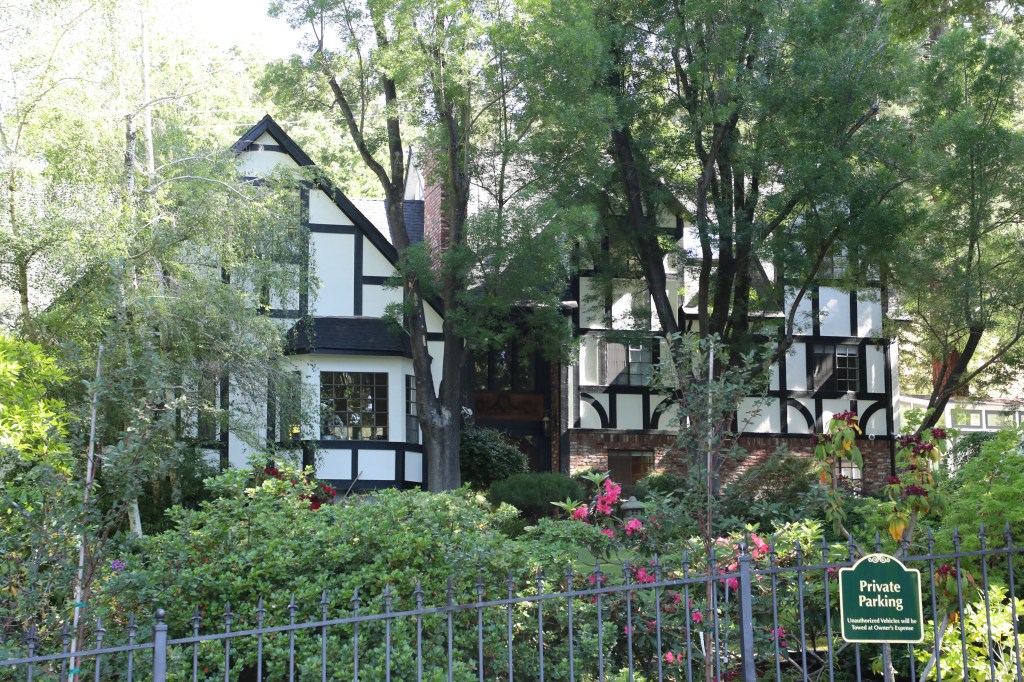 Jie Su's large home is situated  among leafy trees and flowers. 