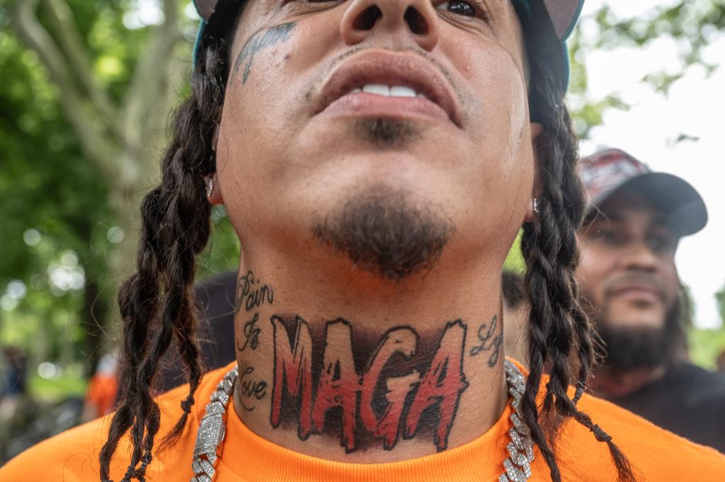 A man's MAGA tattoo on his neck.