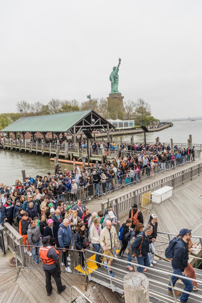 Crowd of tourists including celebrities Marie-Philip Poulin, Selina Chow, and Lung Ying-tai disembarking the Statue of Liberty ferry in New York City on April 30, 2024