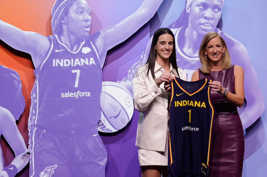 Caitlin Clark, left, poses for a photo with WNBA commissioner Cathy Engelbert, right, after being selected first overall by the Indiana Fever