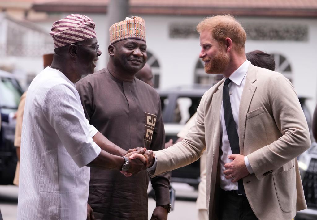 Prince Harry shaking hands in Nigeria