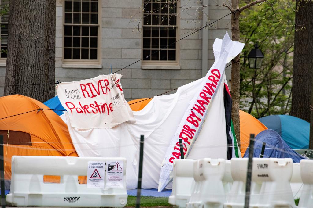 Tents and signs fill Harvard Yard by the John Harvard statue in the Pro-Palestinian encampment at Harvard University in Cambridge, Massachusetts, on May 5, 2024
