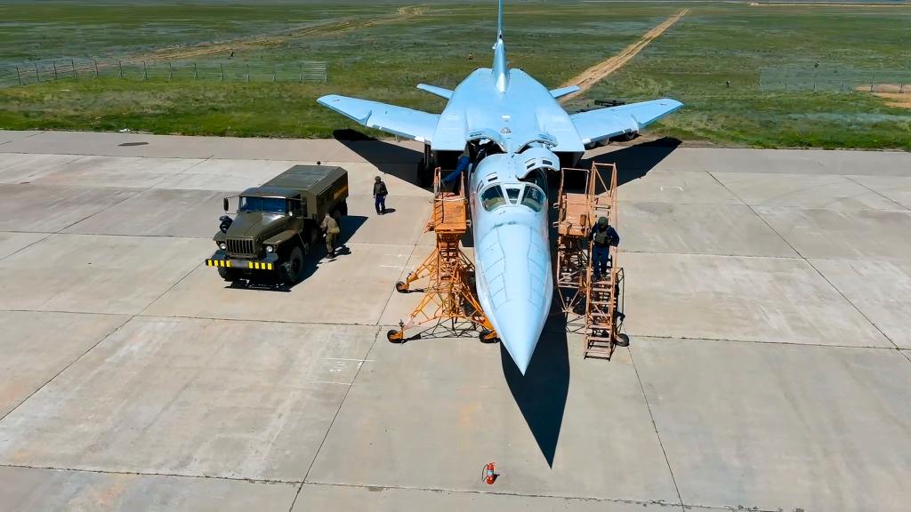 Russian air force crew work to prepare a Tu-22M3 bomber for a training mission