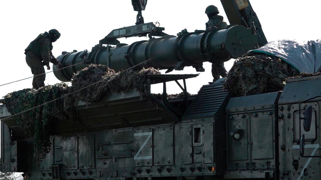 Russian troops load an Iskander missile as part of drills to train the military for using tactical nuclear weapons at an undisclosed location in Russia. 