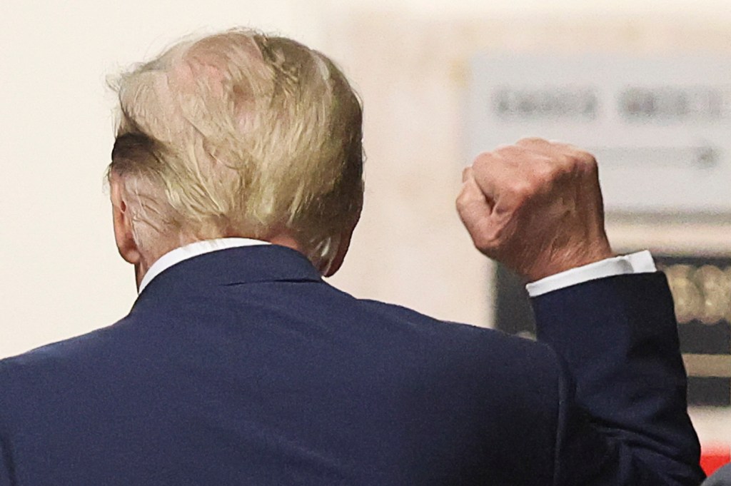  Former US President Donald Trump gestures in the hallway outside the courtroom during a recess in his trial for allegedly covering up hush money payments linked to extramarital affairs, at Manhattan Criminal Court in New York City on April 18, 2024.