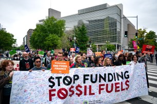 Demonstrators calling for an end to funding fossil fuels at a protest in Washington, DC on April 19, 2024.