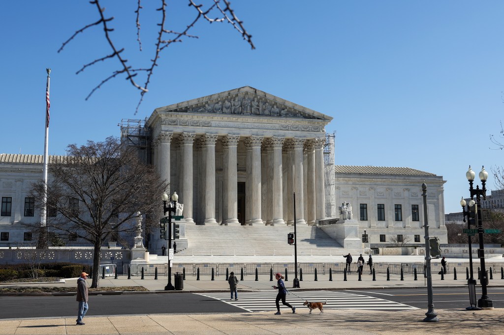 The U.S. Supreme Court building in Washington, D.C. with people walking in front, during a day of bipartisan oral arguments in 2024.