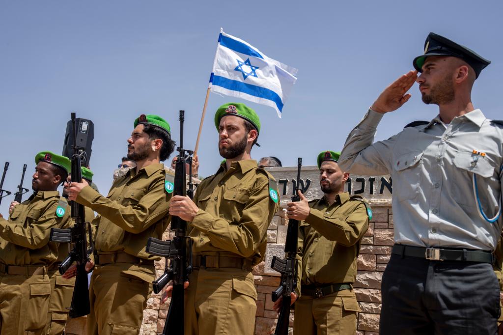 Israeli honor guard soldiers salute during the funeral Israeli reserve Major Dor Zimel in Even Yehuda, Israel, Monday, April 22, 2024.