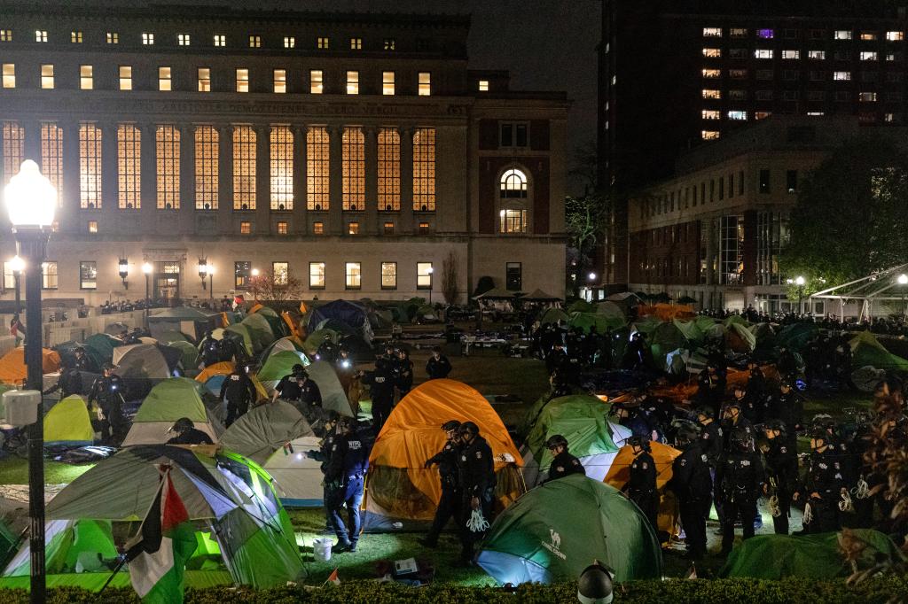 NYPD officers in riot gear enter Columbia University's encampment as they evict a building that had been barricaded.