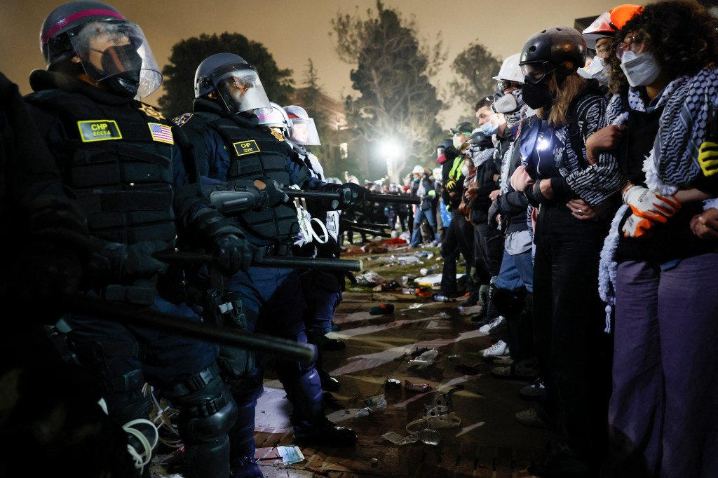 Police face-off with pro-Palestinian students after destroying part of the encampment barricade on the campus of the University of California, Los Angeles (UCLA) in Los Angeles, California, early on May 2, 2024. 