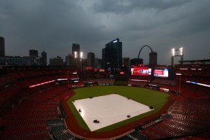 Due to inclement weather, a tarp covers the field at a postponed game between the St. Louis Cardinals and the New York Mets at Busch Stadium on May 8, 2024 in St Louis, Missouri. 