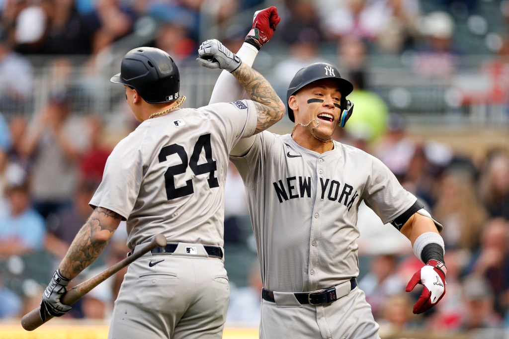 Aaron Judge #99 of the New York Yankees celebrates his solo home run with teammate Alex Verdugo #24 in the first inning against the Minnesota Twins at Target Field on May 15, 2024 in Minneapolis, Minnesota.