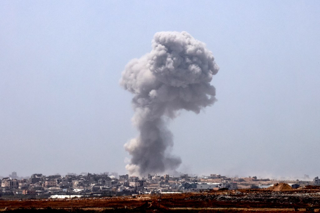 Smoke is seen billowing over Palestinian territory following Israeli bombardment on May 21, 2024.