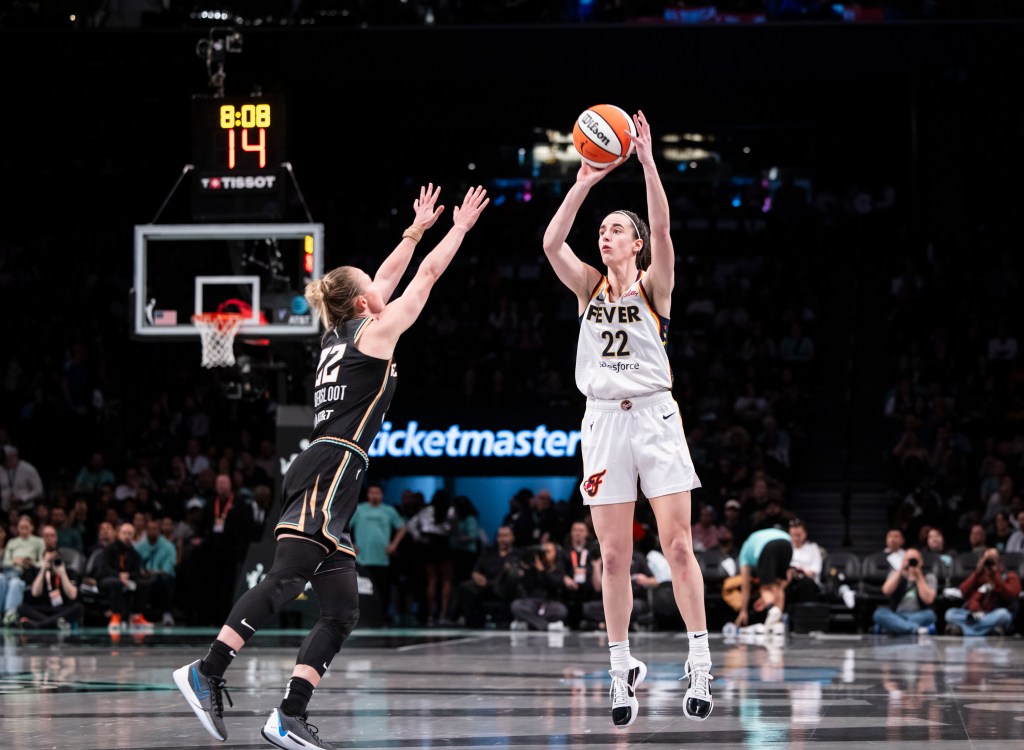 Caitlin Clark makes shot against Courtney Vandersloot at the Liberty's home opener on May, 18.