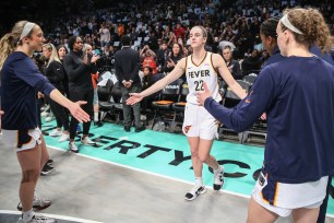 Indiana Fever guard Caitlin Clark enters the court during the starting lineup introductions at Barclays Center before facing the New York Liberty on Saturday.