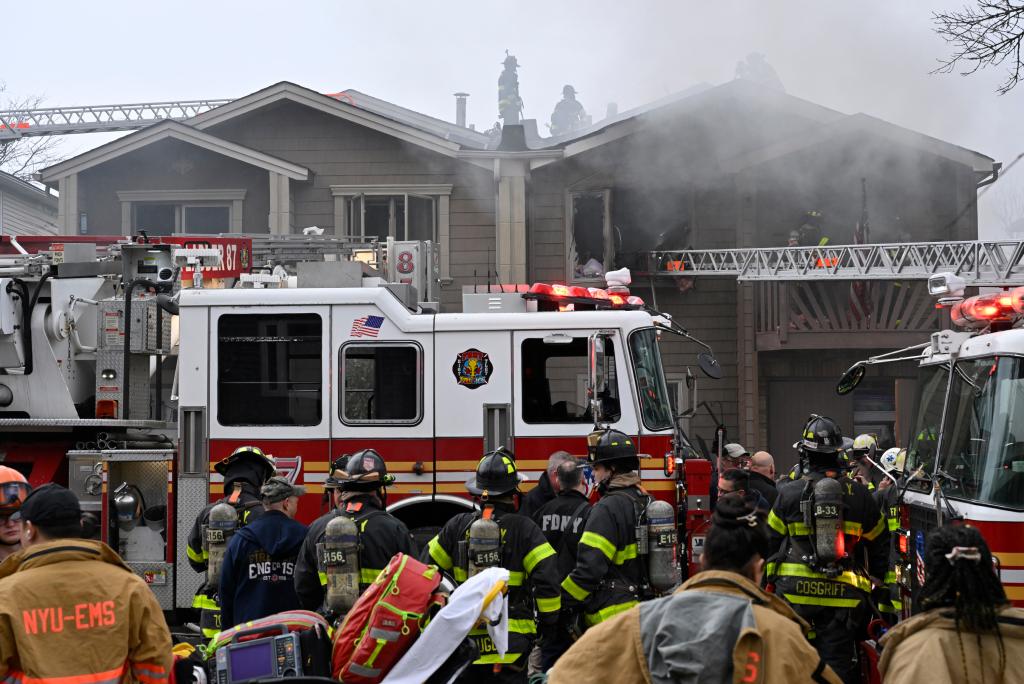 Firefighters working outside a semi-detached house on Shotwell Avenue, Staten Island, which is on fire, on February 17, 2023.