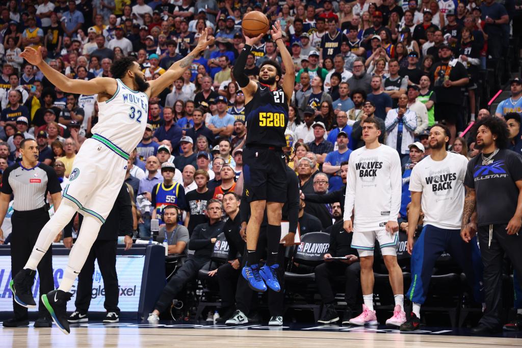 Jamal Murray shoots a three point shot against Karl-Anthony Towns #32 of the Minnesota Timberwolves during the first quarter in Game 7.