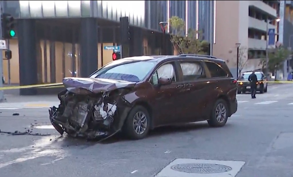 Crashed minivan seen in front of police tape