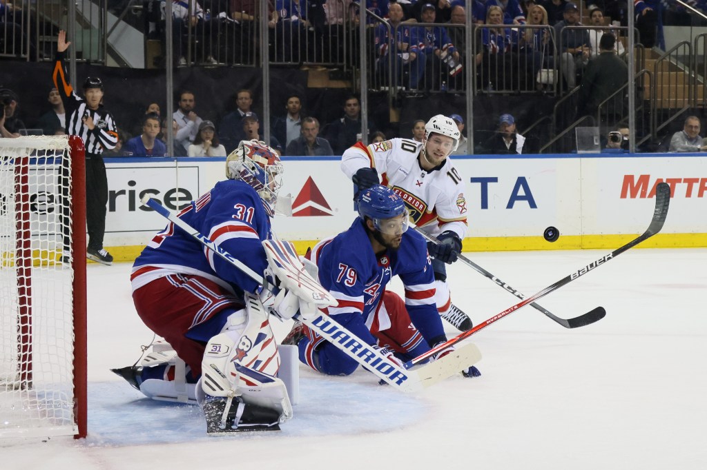 Igor Shesterkin #31 and K'Andre Miller #79 of the New York Rangers defend against Vladimir Tarasenko #10 of the Florida Panthers during the first period.