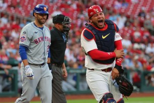 Willson Contreras #40 of the St. Louis Cardinals reacts after getting hit by a bat on a follow through of the swing of J.D. Martinez #28 of the New York Mets in the second inning at Busch Stadium on May 7, 2024