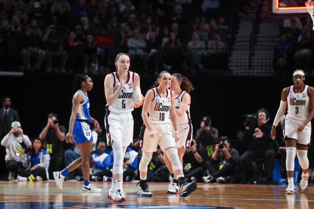 UConn guard Paige Bueckers (5) and guard Nika Muhl (10) react after the team's 53-45 win over Duke in a Sweet 16 college basketball game in the women's NCAA Tournament, Saturday, March 30, 2024, in Portland, Ore.  