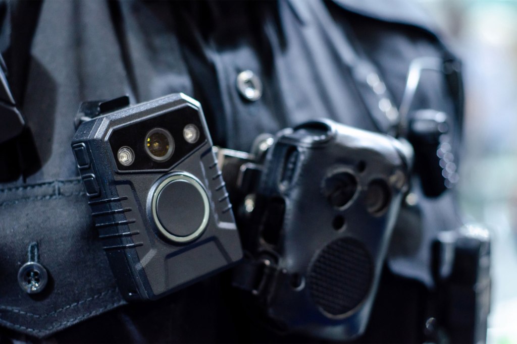 a close up of a body cam on a uniformed officer