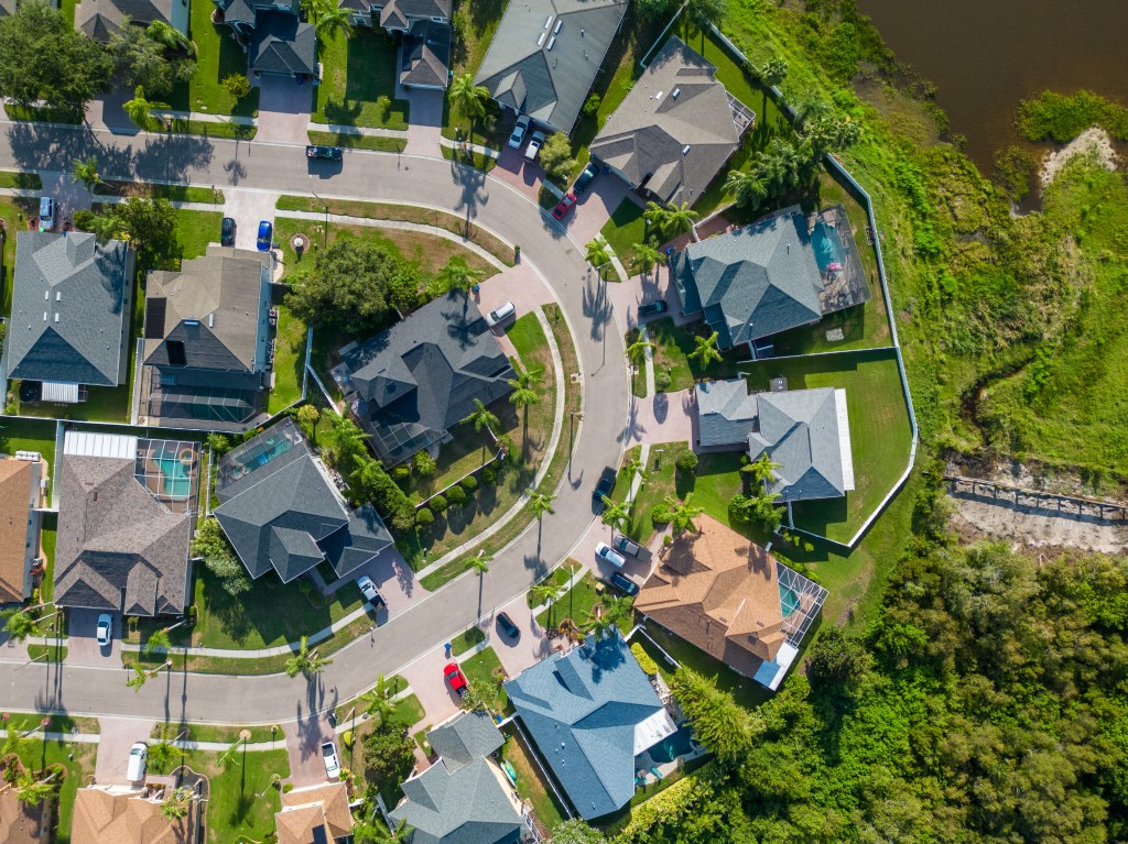 Aerial drone view of a suburban neighborhood in New Port Richey, Florida during summer