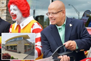 A man in a suit holding scissors next to a man in a clown garment