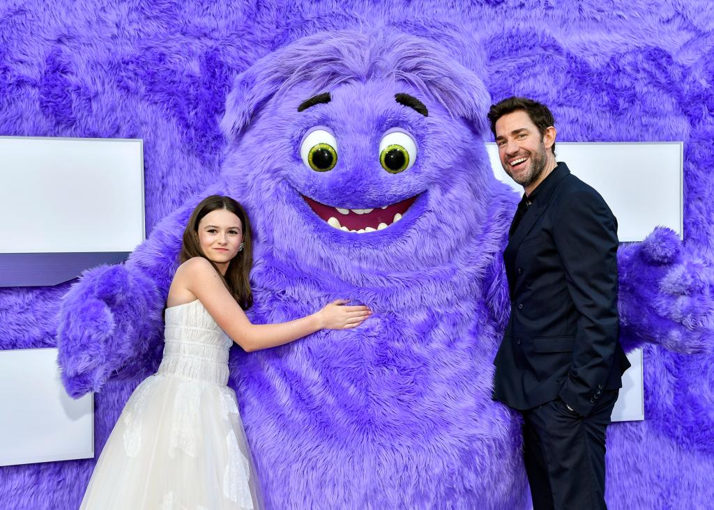 Cailey Fleming and John Krasinski posing with a character named Blue at the premiere of IF in New York