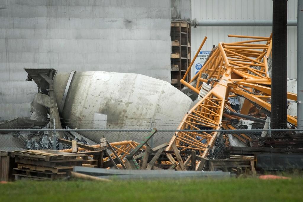 A collapsed trane on top of a cement truck in Houston.