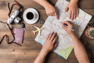 Young couple planning vacation trip with map. Top view. Pointing to Thailand map