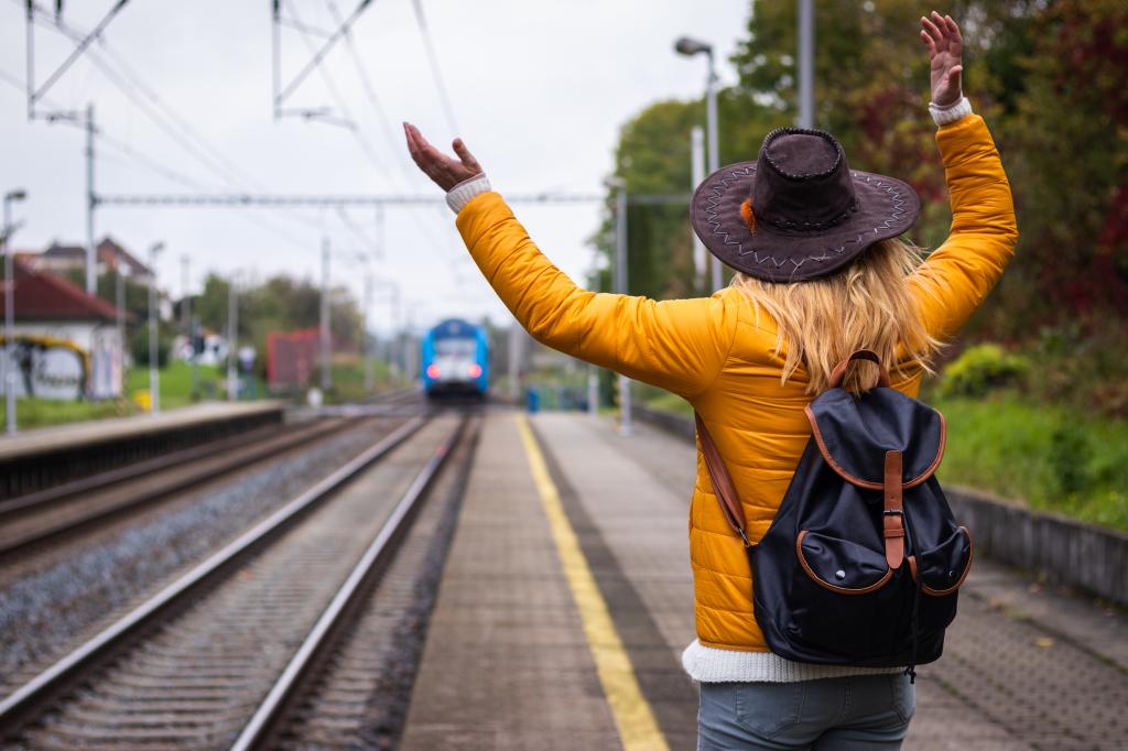 I am late, i missed my train again! Unhappy traveler standing on railroad station and looking to leaving train